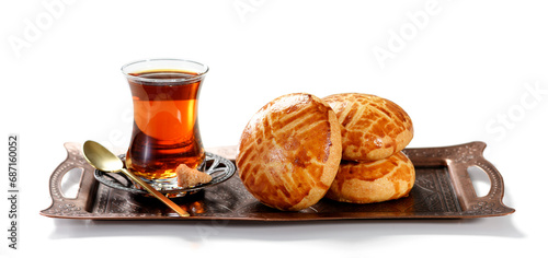 Traditional turkish breakfast buns ( pogaca ) served with black turkish tea. isolated on white background