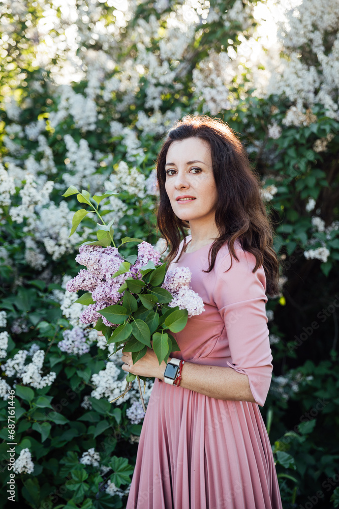 woman with a bouquet of lilacs on a walk nature flowers woman with a bouquet of lilacs on a walk nature flowers