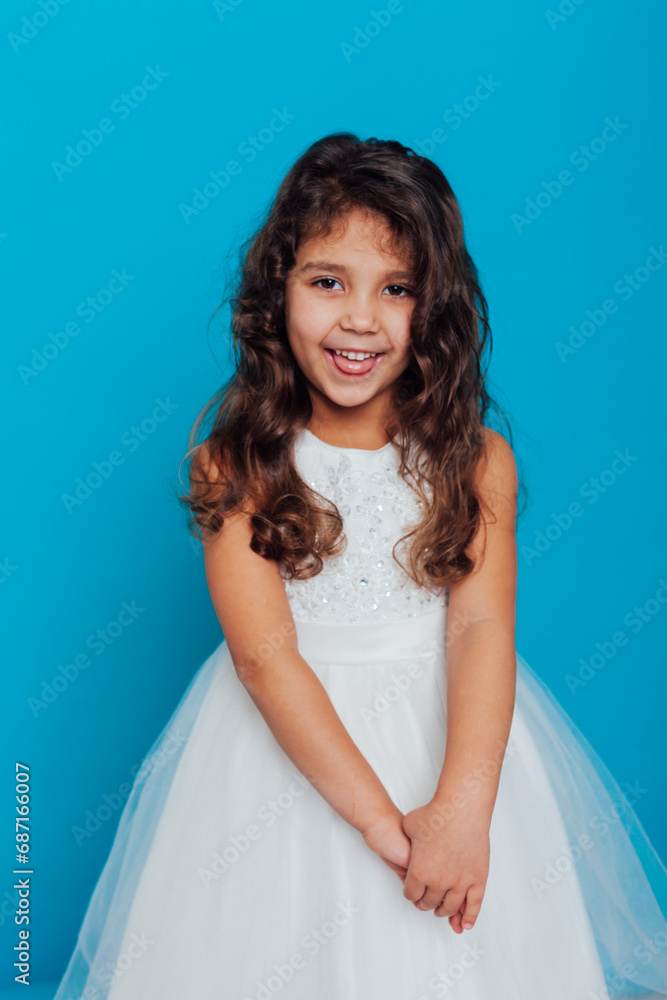 Girl in white elegant dress on a blue background Holiday Girl in white elegant dress on a blue background Holiday