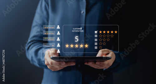 Customer service and Satisfaction concept ,Business people are touching the virtual screen on the happy Smiley face icon to give satisfaction in service. rating very impressed. 