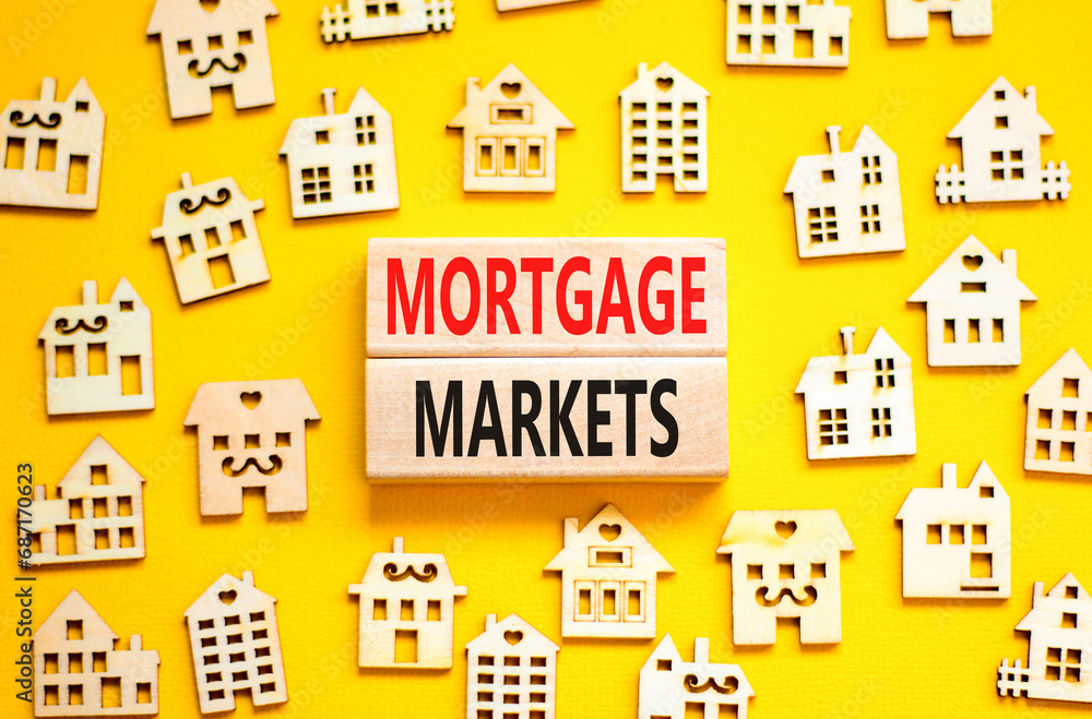 Mortgage markets symbol. Concept words Mortgage markets on beautiful wooden blocks. Beautiful yellow table yellow background. House model. Business mortgage markets concept. Copy space.