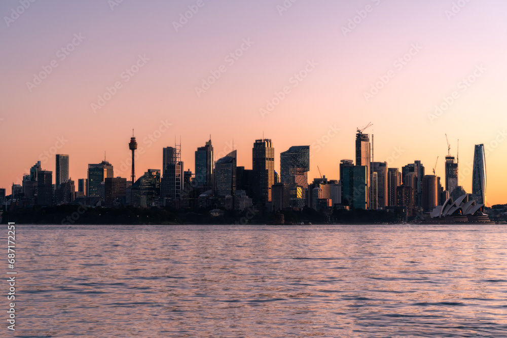 Sydney city view at the sunset time with water in foreground and select focus on the middle of building. Sydney CBD, Central Business 
