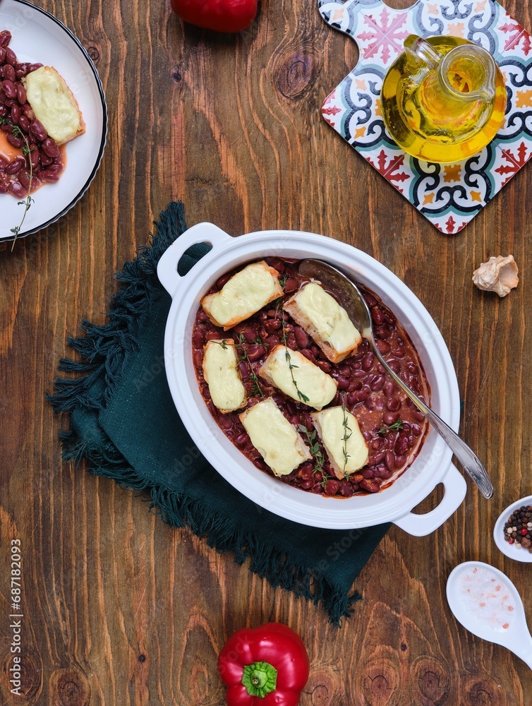 custom made wallpaper toronto digitalFish baked in sour cream sauce with beans in tomato in a white ceramic form on a brown wooden background. Recipes: beans, fish.