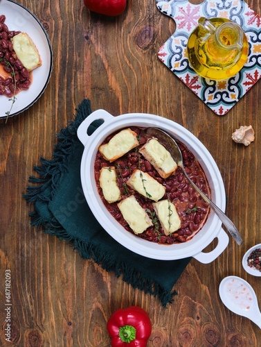 Wallpaper Mural Fish baked in sour cream sauce with beans in tomato in a white ceramic form on a brown wooden background. Recipes: beans, fish. Torontodigital.ca