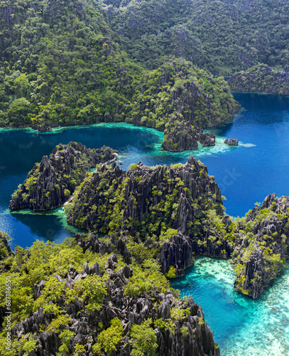 aerial photography of paradisiacal islands of indonesia, philippines tropical vacations with blue water and green jungle photo