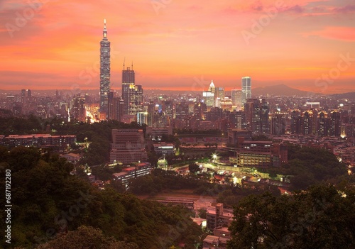 Aerial panorama of Taipei City with Taipei 101 Tower among skyscrapers in downtown area at dusk ~ A romantic evening in Taipei, the capital city of Taiwan, with beautiful rosy afterglow in the sky