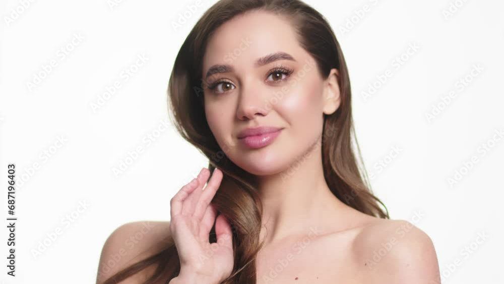 Portrait of an attractive dreamy tender girl doing a face and neck massage, isolated on a light background. Self care concept. Advertising of cosmetology and cleanliness. Portrait of an attractive dreamy tender girl doing a face and neck massage, isolated on a light background. Self care concept. Advertising of cosmetology and cleanliness.