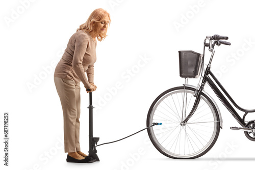 Woman using a manual pump for a flat bicycle tire photo