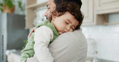 Father, baby and sleeping on shoulder in home with love, care and support. Dad carrying tired, young and calm infant kid for nap, childhood development and singing lullaby for comfort in family house photo