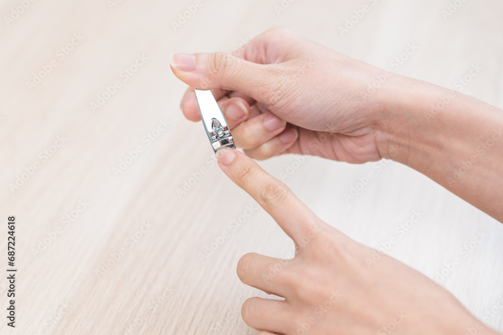 Nail good hygiene, young woman hand manicure with nail clipper cutting fingernail on long or dirty finger, using nail sharp clipper make with stainless steel. Healthy care clean body by cut short trim Nail good hygiene, young woman hand manicure with nail clipper cutting fingernail on long or dirty finger, using nail sharp clipper make with stainless steel. Healthy care clean body by cut short trim