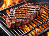 Close-up of beef steak on the grill. Beef steak on the grill with flames of fire.