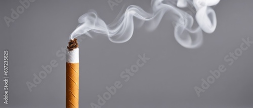 Burning Cigarette on a Gray Background with smoky