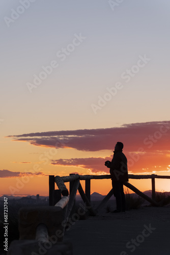A man admires the sunset from the viewing platform. Spain, Costa Blanca
