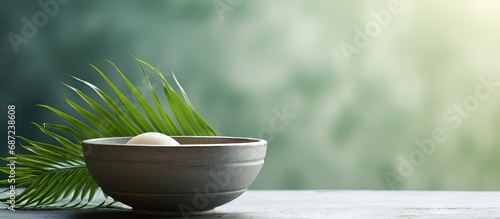 Stock photo of a bowl of ash with palm leave cross representing Lent Holy Week and Good Friday Copy space image Place for adding text or design