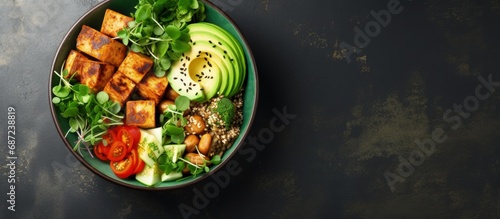 Vibrant buddha bowl featuring grilled tofu and pea shoots Copy space image Place for adding text or design photo