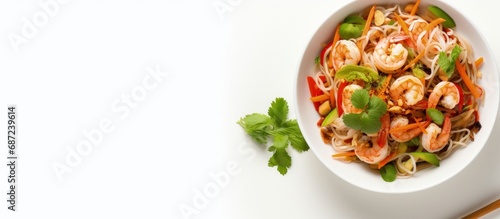 Top view of Thai street food concept featuring a spicy seafood salad with vermicelli and vegetables on a white wooden background Copy space image Place for adding text or design