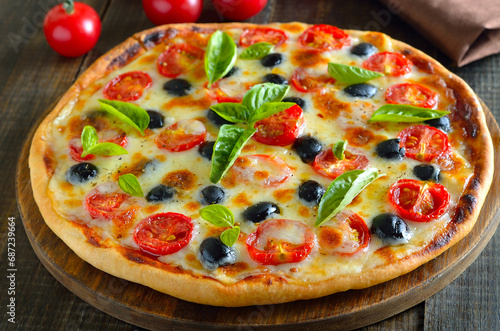 Homemade pizza with tomato and olives