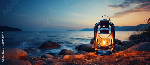 Vintage oil lantern by the sea Evening Colorful illuminated lamp Travel concept Copy space image Place for adding text or design photo