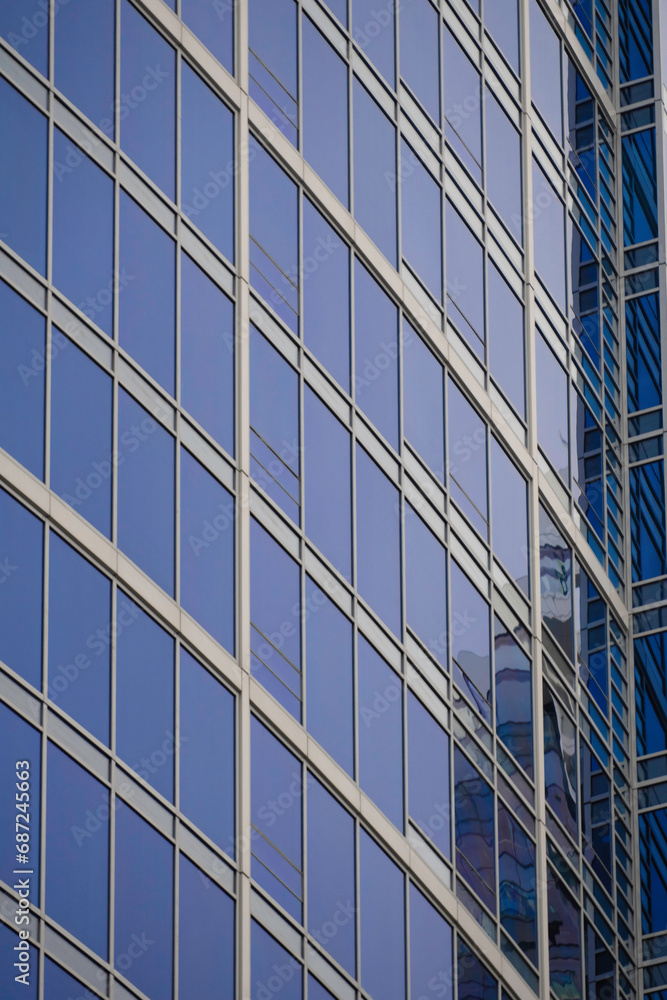 Modern glass office building with reflective windows in the city Modern glass office building with reflective windows in the city
