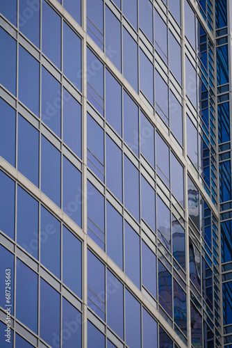 Modern glass office building with reflective windows in the city