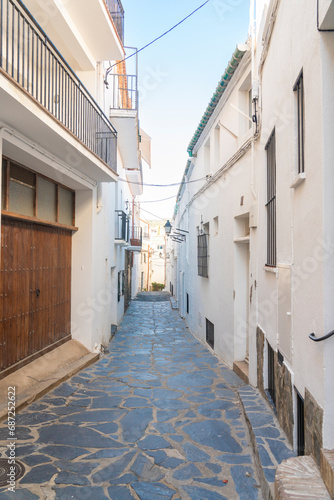 streets of a fishing town with white and blue houses in summer days © Carlos javier