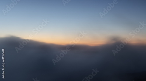 Long exposure shot of clouds moving at sunrise.