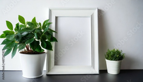on a pristine white background a potted green plant accompanies an empty white photo frame waiting for memories to be captured