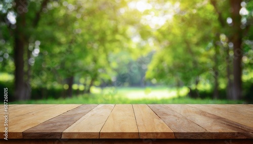 wood table top on blur green background of trees in the park