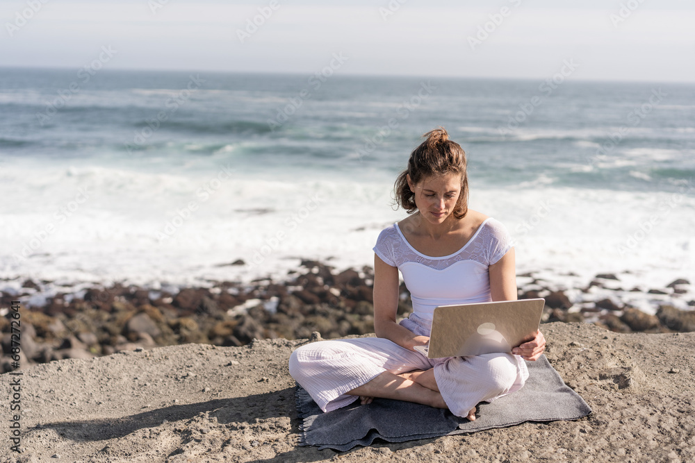 Girl freelancer doing work on the ocean