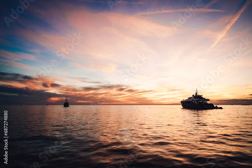 Quadro em tela Silent and still, a solitary boat floats upon the tranquil waters, surrounded by