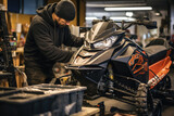 A mechanic servicing a snowmobile in a subzero workshop 