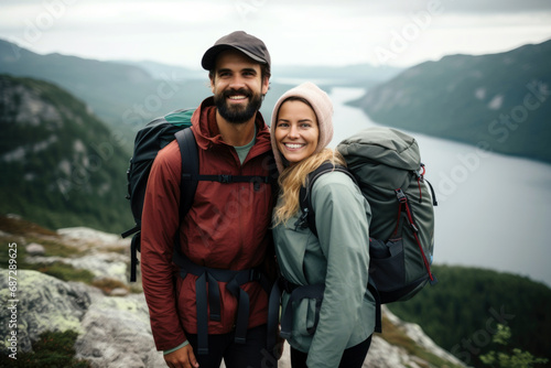 Two people hiking in a beautiful mountain landscape with water.