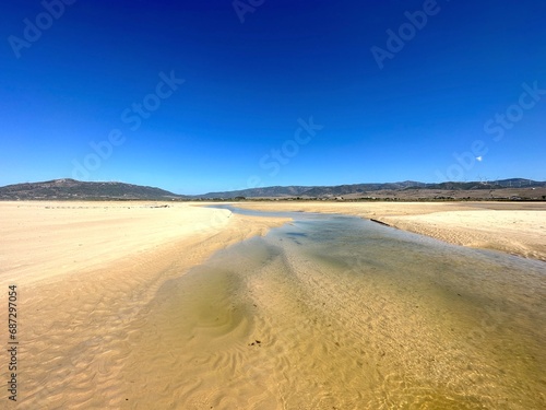 Rio de la Jana flows into the Atlantic on the beach near Tarifa  view of the Andalusian mountains  Costa de la Luz  Spain