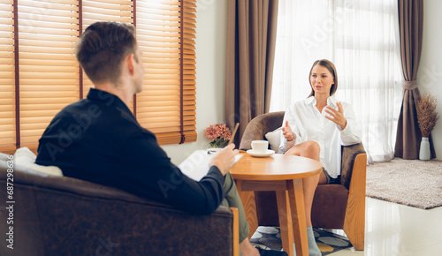 Psychological consultation gaining improvement on mental problem, happy young female patient doing therapy session while psychiatrist making diagnostic on mental illness. Unveiling photo