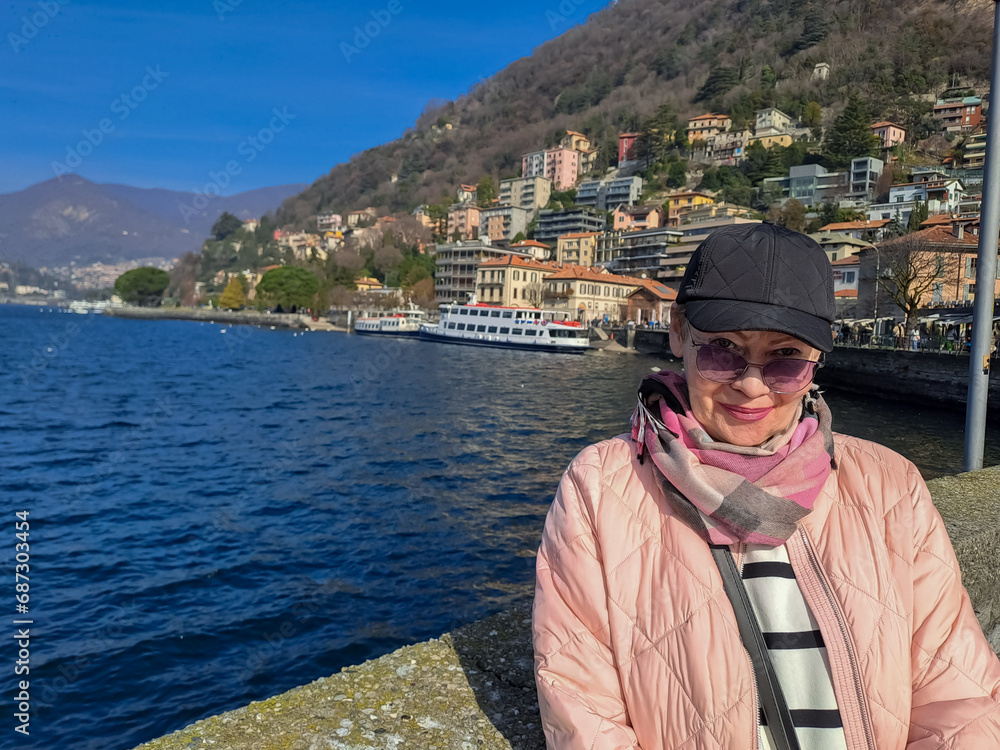 Portrait of a mature woman on the shores of Lake Como. End of February