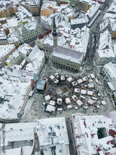 Bird's eye view of the Christmas market in Tallinn's old town townhall square on a cloudy day.