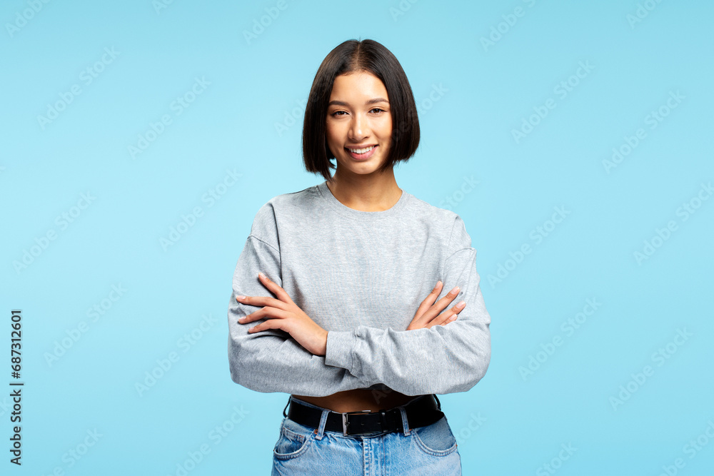 Portrait attractive Asian woman wearing stylish casual clothes with crossed arms looking at camera - obrazy, fototapety, plakaty 