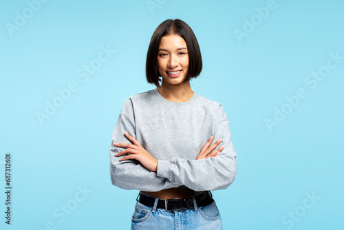 Portrait attractive Asian woman wearing stylish casual clothes with crossed arms looking at camera