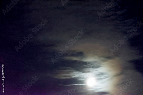 Venus and the moon and clouds , in the dark night