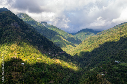 travel to Georgia - gray clouds over overgrown mountains in Machakhela national park in Adjara on sunny autumn day