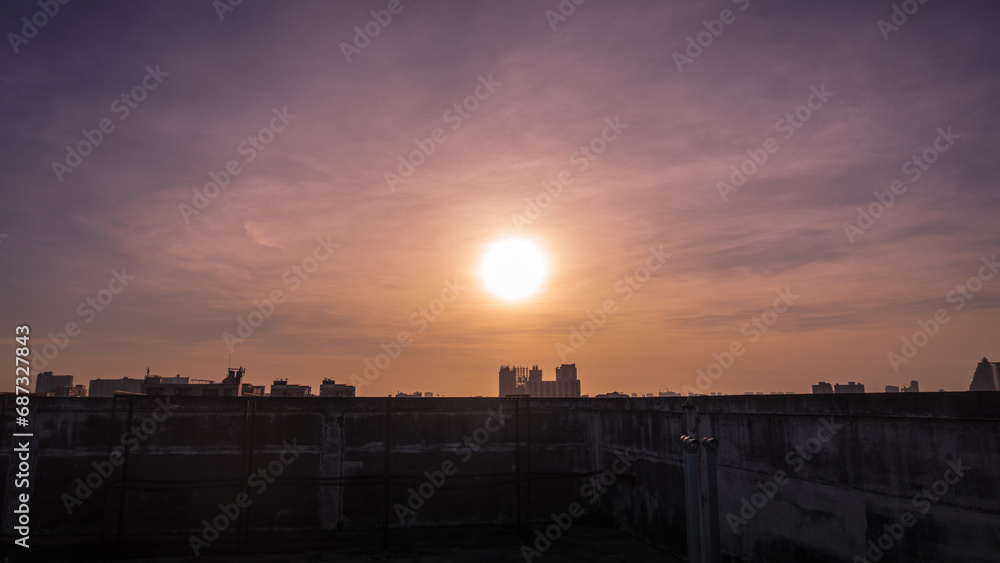 Sunset in Bangkok, Thailand, silhouette of big building in city with dramatic vanilla sky for background.