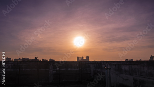 Sunset in Bangkok, Thailand, silhouette of big building in city with dramatic vanilla sky for background.