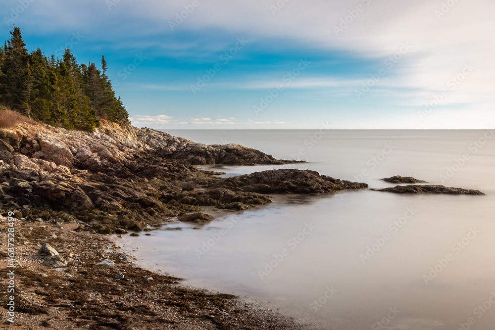 Serene coastal rocky beach with calm water Serene coastal rocky beach with calm water