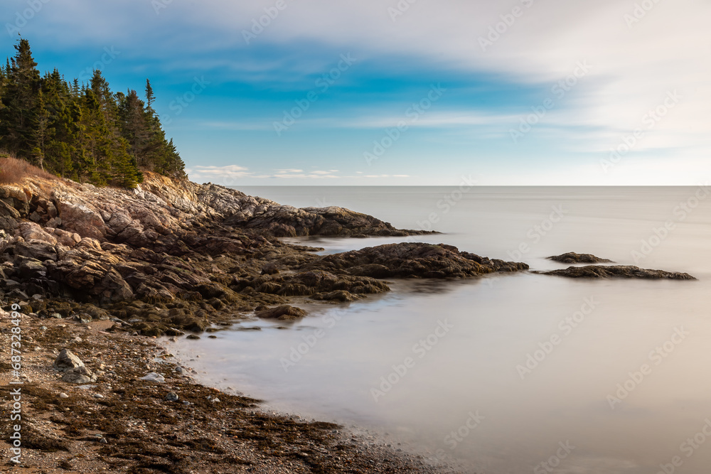 Serene coastal rocky beach with calm water