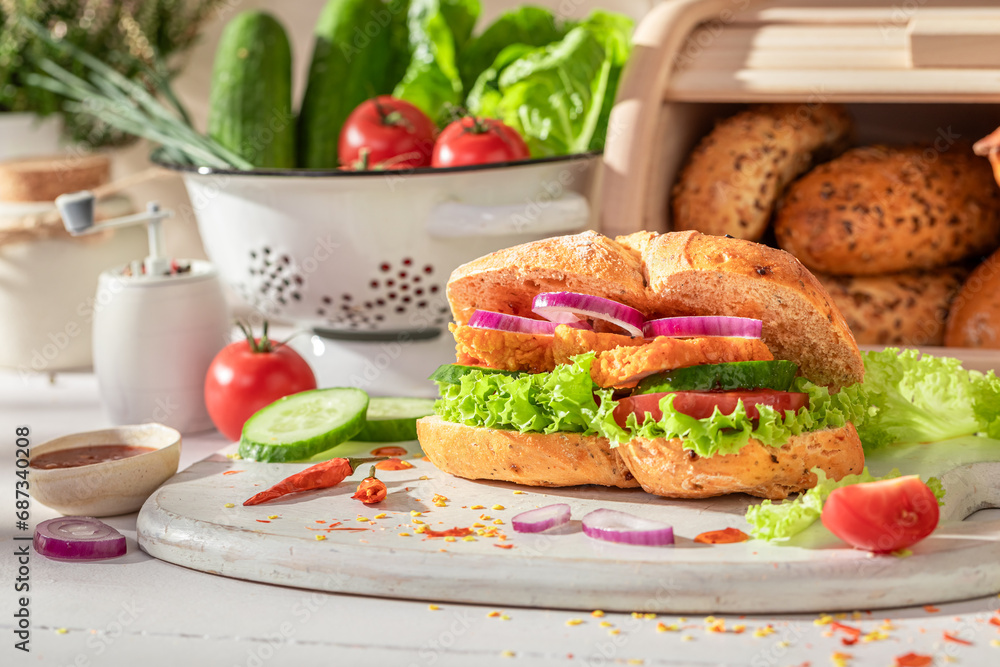 Spicy and delicious sandwich with chicken, tomato and lettuce - obrazy, fototapety, plakaty 