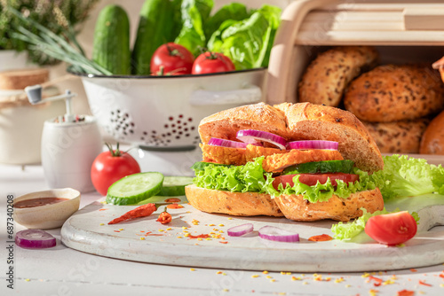 Spicy and delicious sandwich with chicken, tomato and lettuce photo
