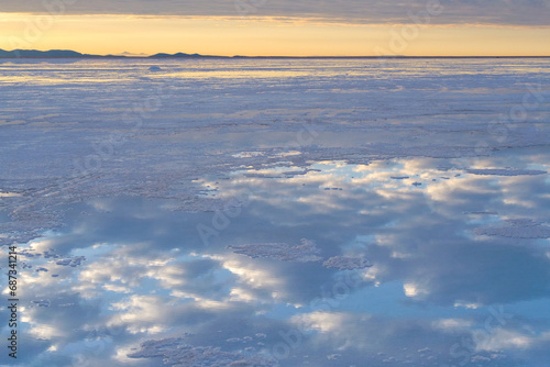Reflections of white clouds and the blue sky on the surface of the Uyuni Salt Flat Lake  Bolivia  a popular travel destination
