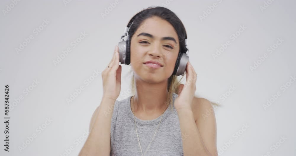 Dance, headphones and face of woman in studio listening to audio, streaming song and radio. Happy, dancing and portrait of person with music for energy, subscription and fun on gray background Dance, headphones and face of woman in studio listening to audio, streaming song and radio. Happy, dancing and portrait of person with music for energy, subscription and fun on gray background