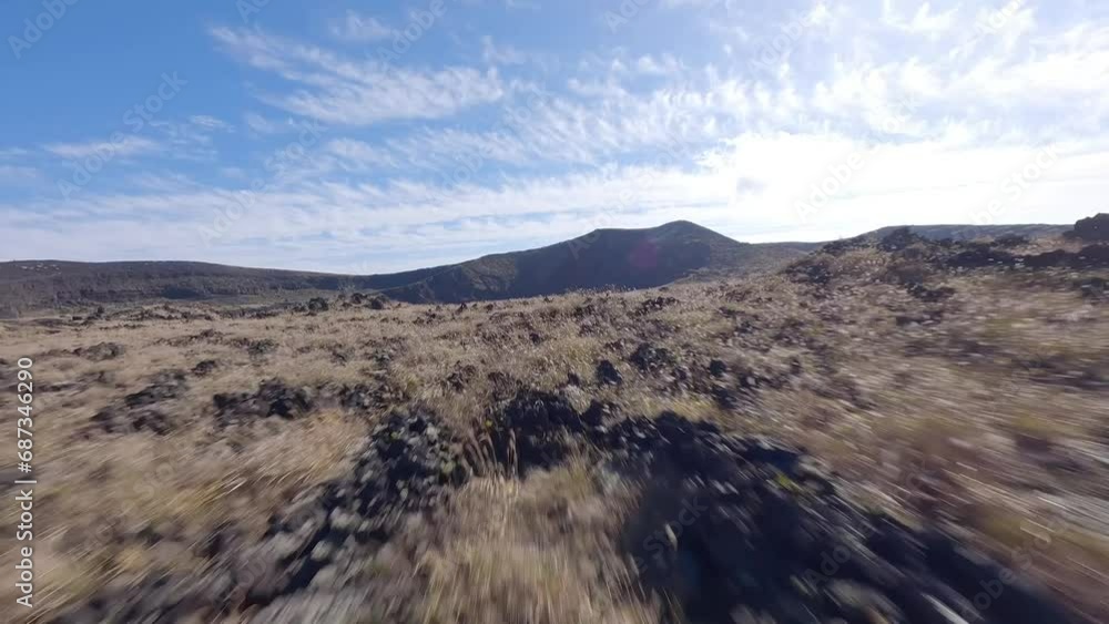 FPV Birdseye view of flying over a volcano mountain in Oshima island Tokyo Japan FPV Birdseye view of flying over a volcano mountain in Oshima island Tokyo Japan