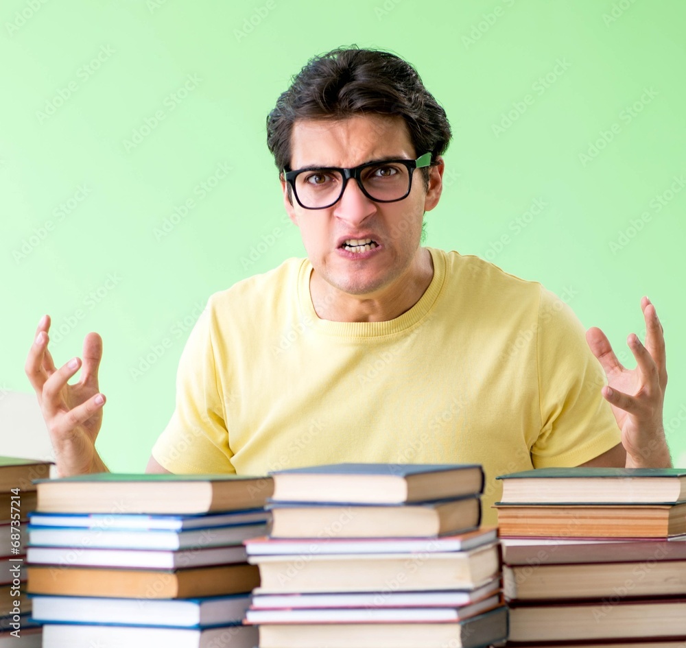 Student with too many books to read before exam Student with too many books to read before exam